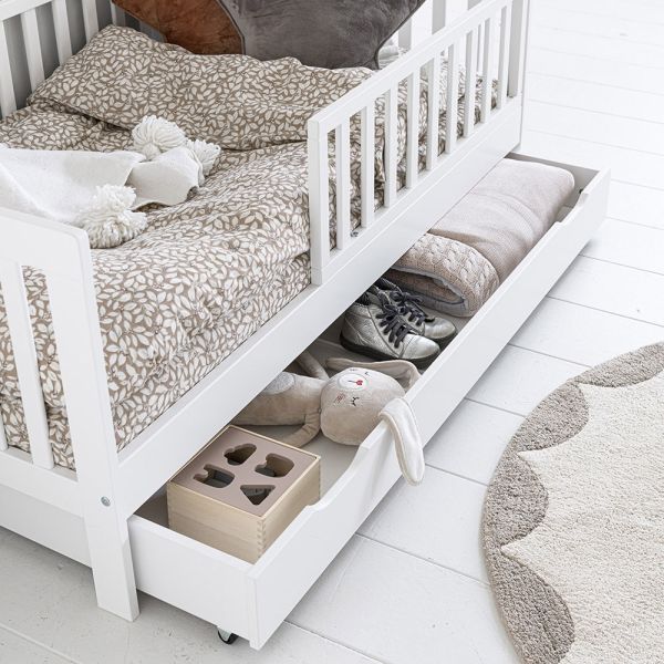Toddler bed with storage drawer